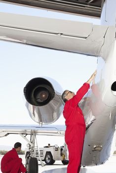 Aeronautical engineers inspecting airplane