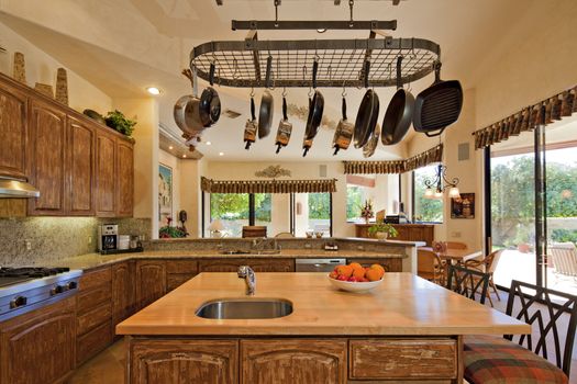 Kitchen counter with utensils hanging in luxury villa