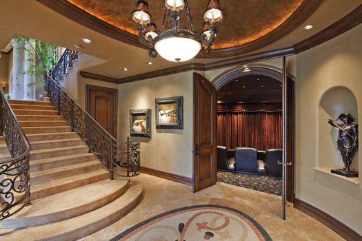 Hallway with stairway and open door in luxury mansion