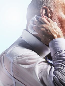 Middle Aged Businessman wiping sweat from back of neck close-up side view
