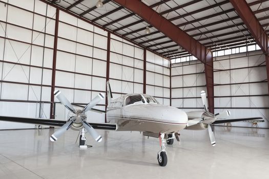 Private airplane parked in hangar