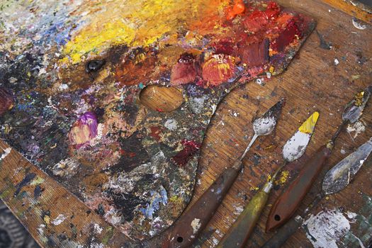 Artist's Palette and Palette Knives Covered in Paint