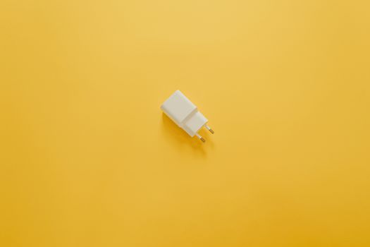 A white charger over a yellow table