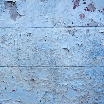 grungy blue painted cracked part of outside wall