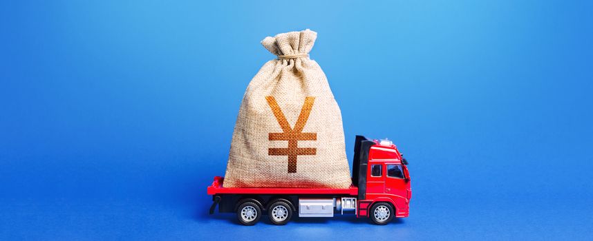 The truck is carrying a huge Yen Yuan money bag. Great investment. Anti-crisis measures of government. Attracting large funds to the economy for subsidies, support and cheap soft loans for businesses.