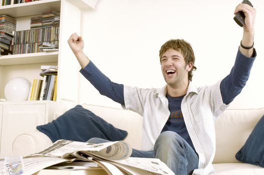 Young Man Watching Television and Cheering
