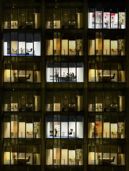 Cross section of office block with people working view from building exterior (full frame)