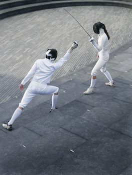 Two athletes fencing on steps of the Scoop amphitheatre London England elevated view