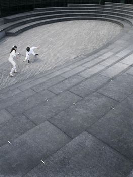 Two athletes fencing in the Scoop amphitheatre London England elevated view