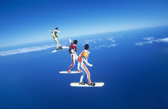 Three people skyboarding against blue sky