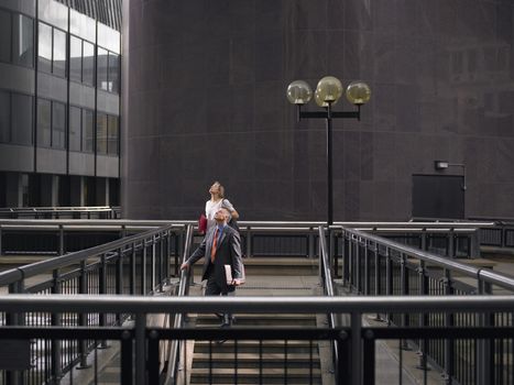 Portrait of Two people walking down stairs while looking up