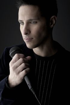 Young man holding microphone close-up