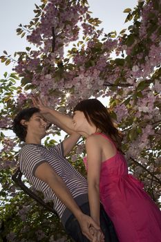 Young Couple Dancing Under a Blossoming Tree