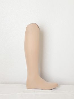 Artificial leg over gray wall