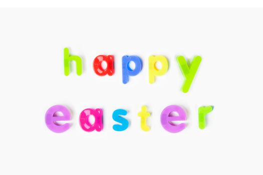 Colorful alphabet magnets spell 'happy Easter' over white background