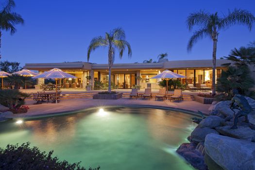 view across a pool to patio of luxury home