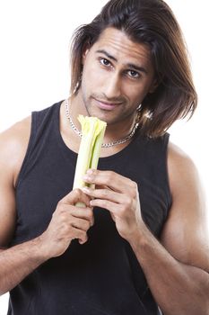 Portrait of masculine man holding vegetable in studio