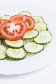 Close-up  of sliced tomatoes and cucumbers in plate