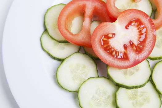 Close-up  of sliced tomatoes and cucumbers in plate