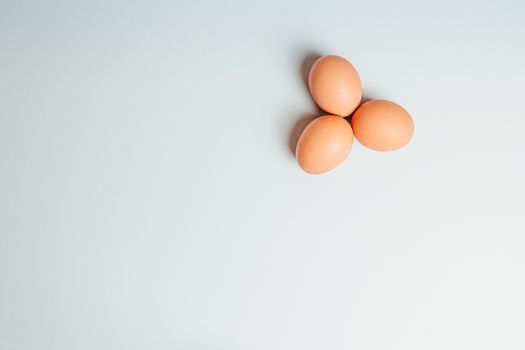 White background with three eggs in a corner