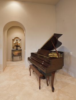 Baby grand piano in corner of luxury home