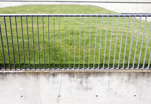Metal railings in front of grass