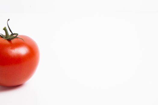 Cropped shot of tomato over white background