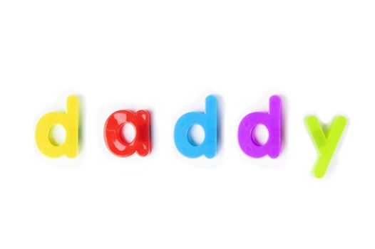 Colorful alphabet magnets spell 'daddy' over white background