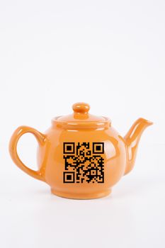 Close-up of orange kettle with barcode over white background