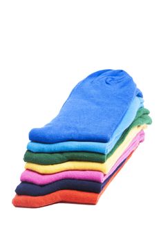Colorful pile of folded socks over white background