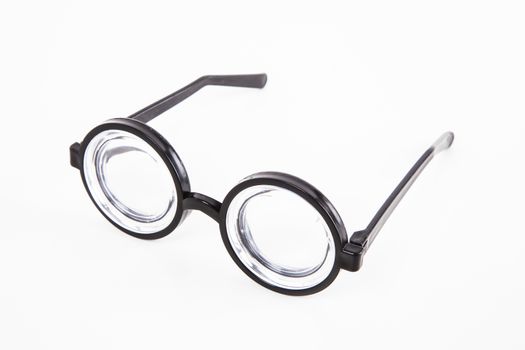 Close-up of thick glasses over white background