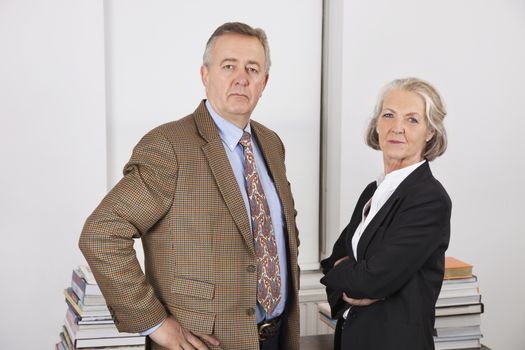 Portrait of confident businessman and woman in office