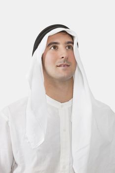 Arab businessman looking away against white background