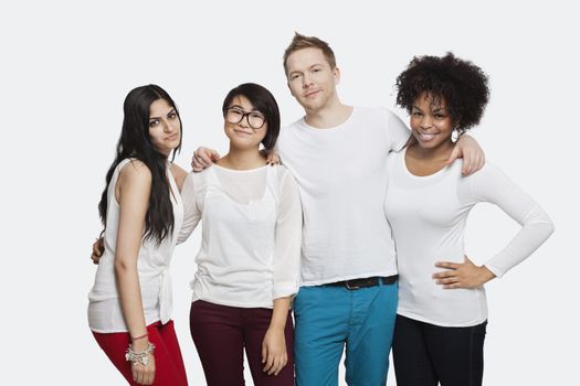 Portrait of multi-ethnic friends in casuals smiling over white background