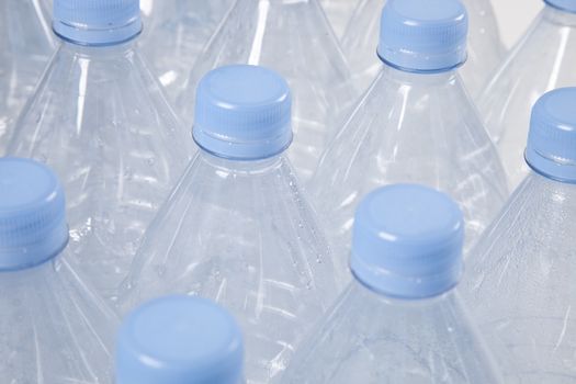 Close-up view of empty plastic bottles with blue caps