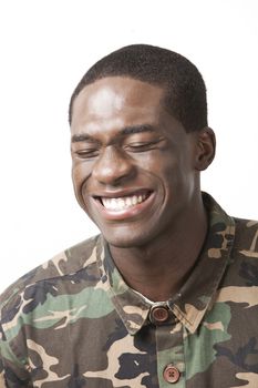 Happy young military soldier in camouflage clothing over white background