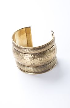 Trendy gold bracelet over white background