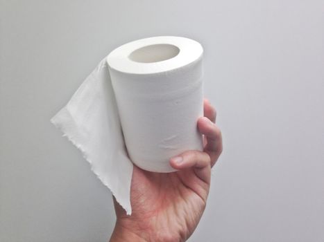 White toilet paper hold with left hand