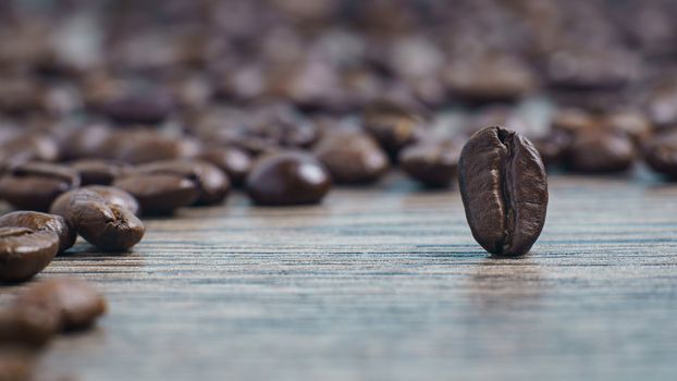 Coffee beans stands  on a wooden background.