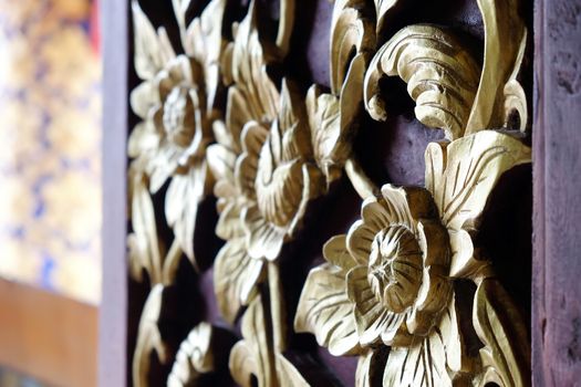 Detail of wood carved window decoration at Phuket temple in Pua district, Nan province, Thailand