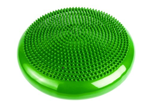 Green inflatable balance disk isoleated on white background, It is also known as a stability disc, wobble disc, and balance cushion.