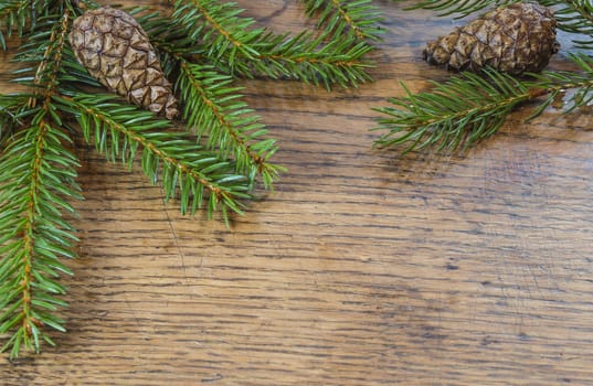 horizontal christmas decoration frame spruce tree fir branch with cone on old hardwood wooden desk background