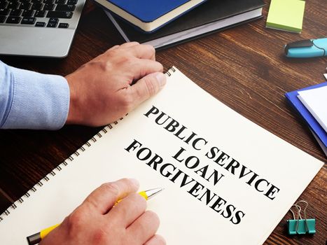Public service loan forgiveness program PSLF on the desk.