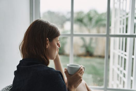 Upset woman with a cup of coffee in the morning