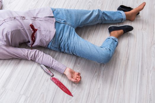 Dead woman on the floor after commiting suicide