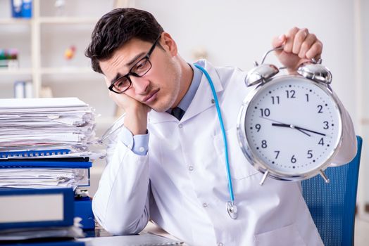 Doctor with alarm clock in urgent check-up concept