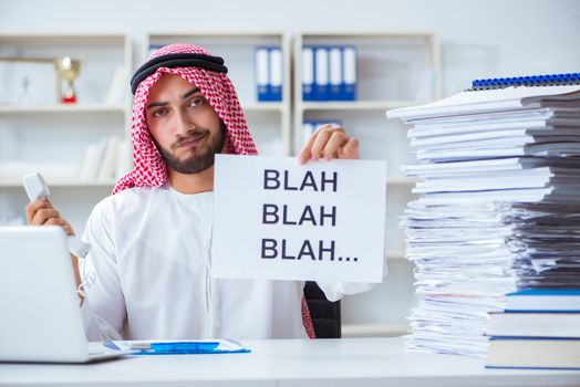 Arab man sitting at desk with message