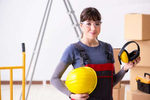 Woman contractor worker with noise cancelling headphones