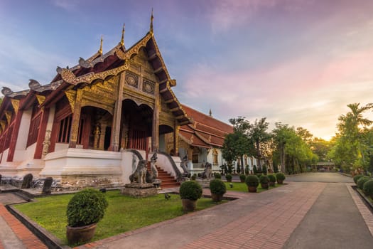 Wat Phra Singh temple pavilion at pink sunrise. Chiang Mai, Thailand.