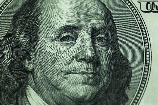 Benjamin Franklin's gaze on a hundred dollar bill